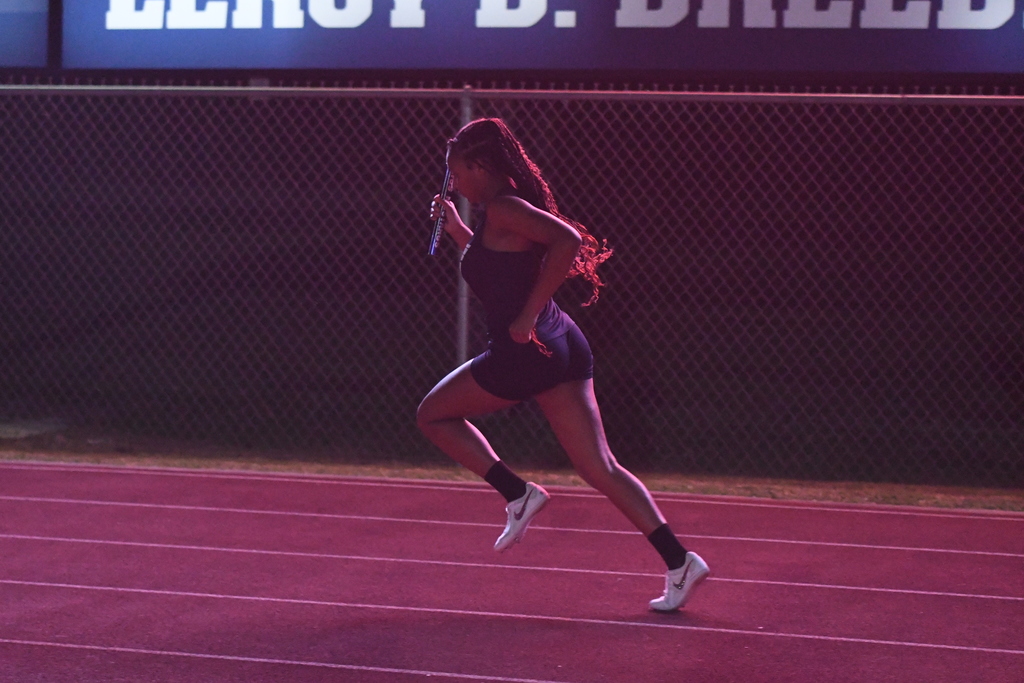 wos relay runner backlit from scoreboard