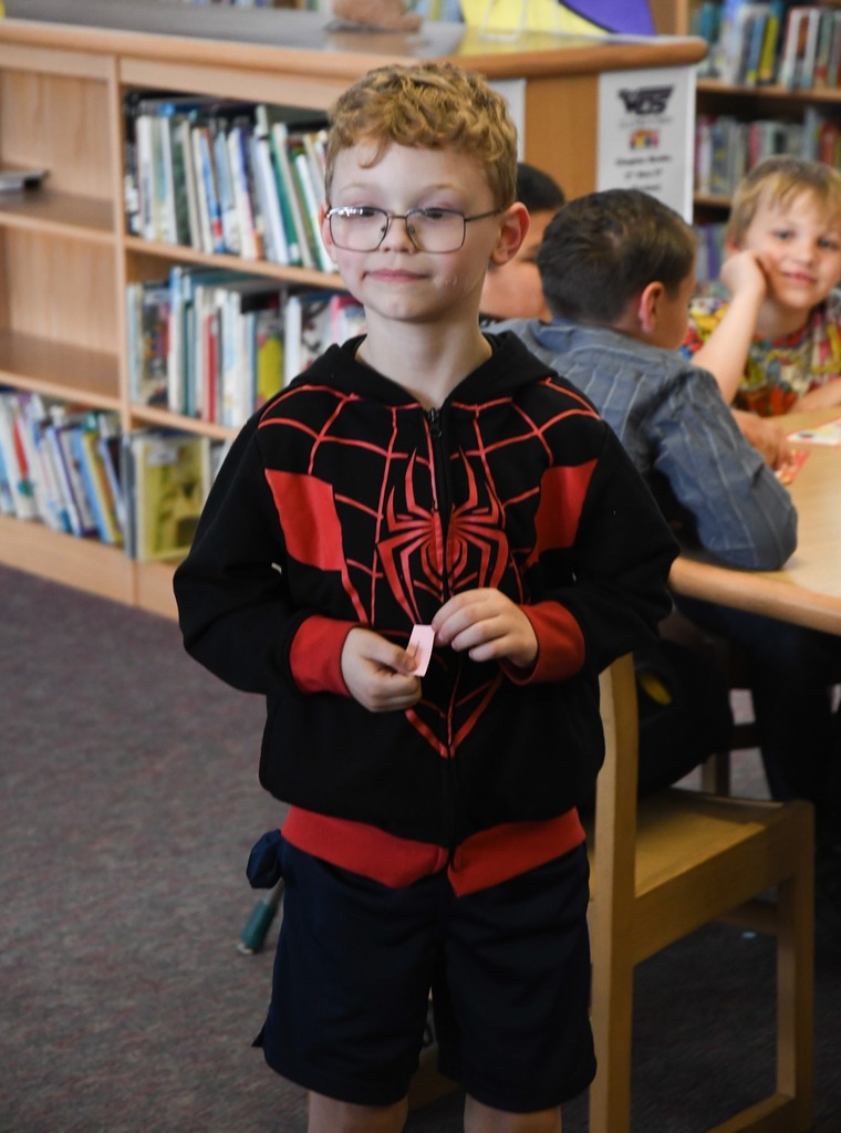 student holding winning ticket from bingo