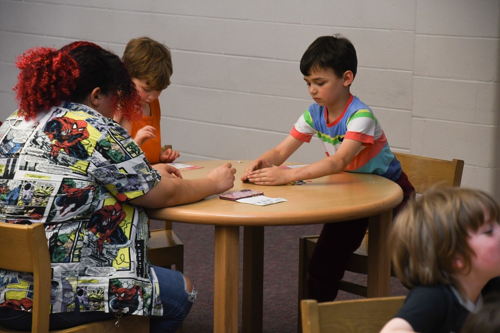student moving pieces on bingo card