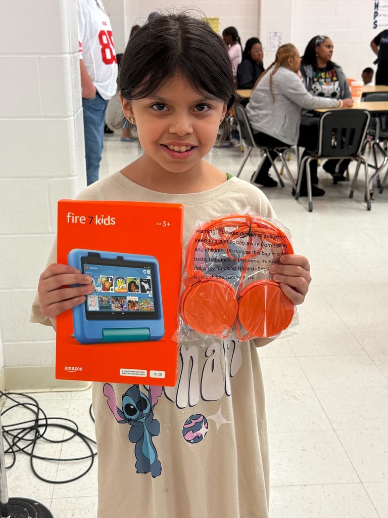 student holding prizes from bingo raffle