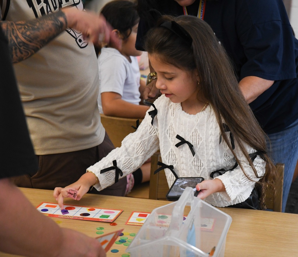 student placing piece on a bingo card