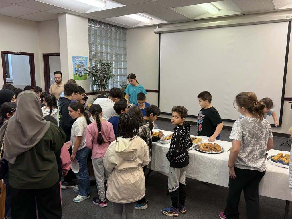Students standing in line and getting food. 