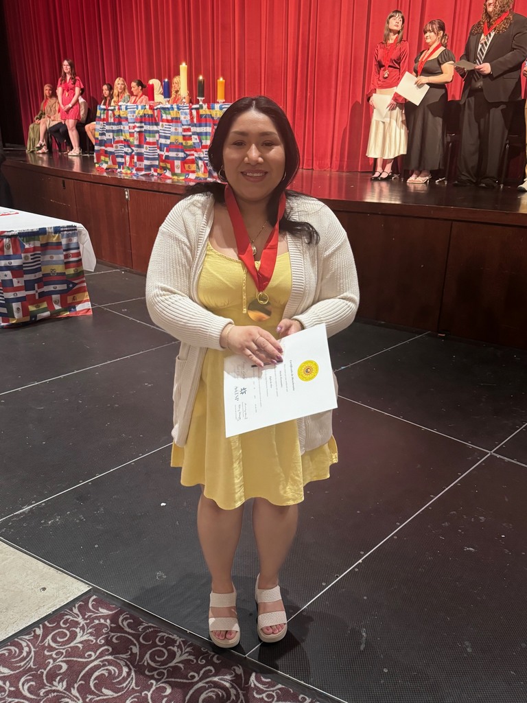 Honorary inductee for spanish NHS  holding her certificate owner of La Casa Mexicana