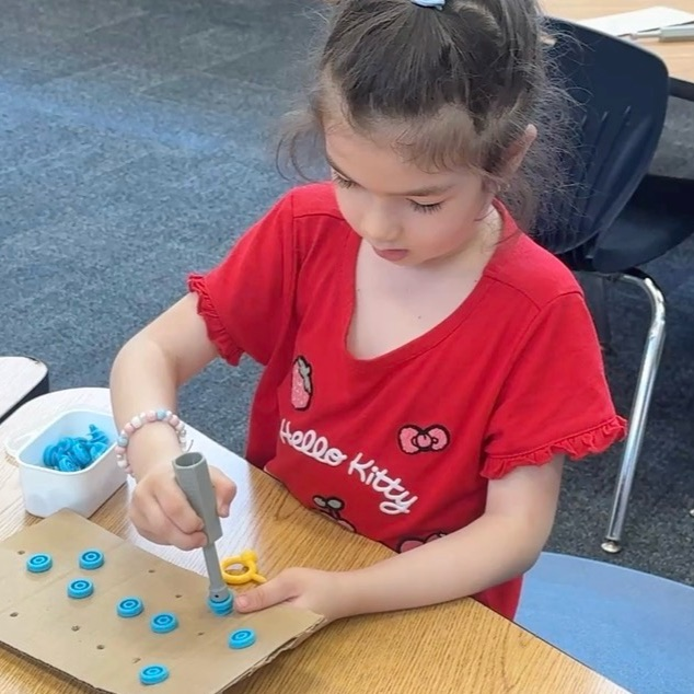 student practicing a screwdriver