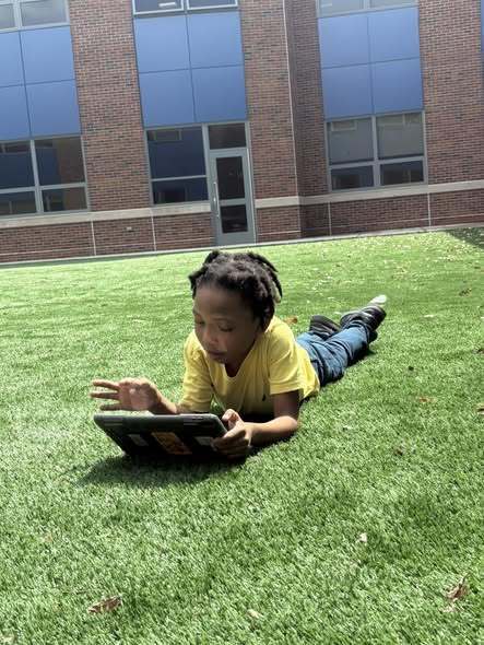 A student using their ipads and learning outside.