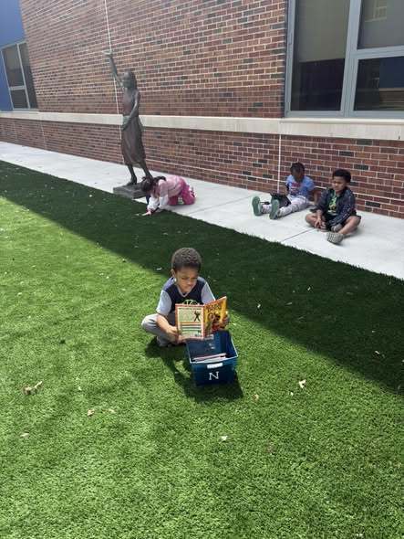 Students using their ipads and learning outside.