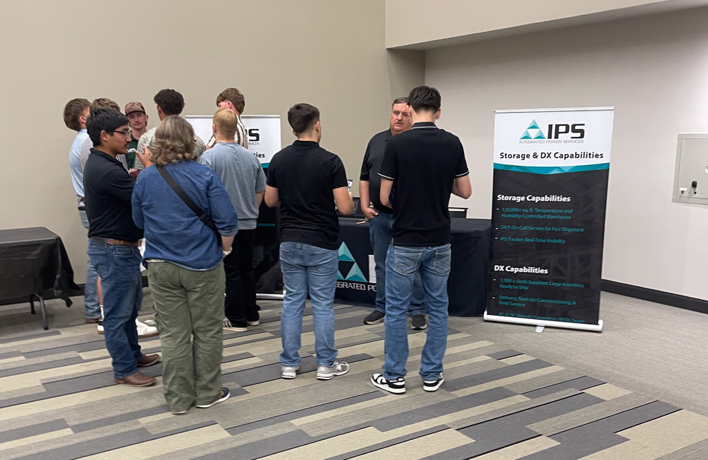WOS students talking to a local manufacturing company representative