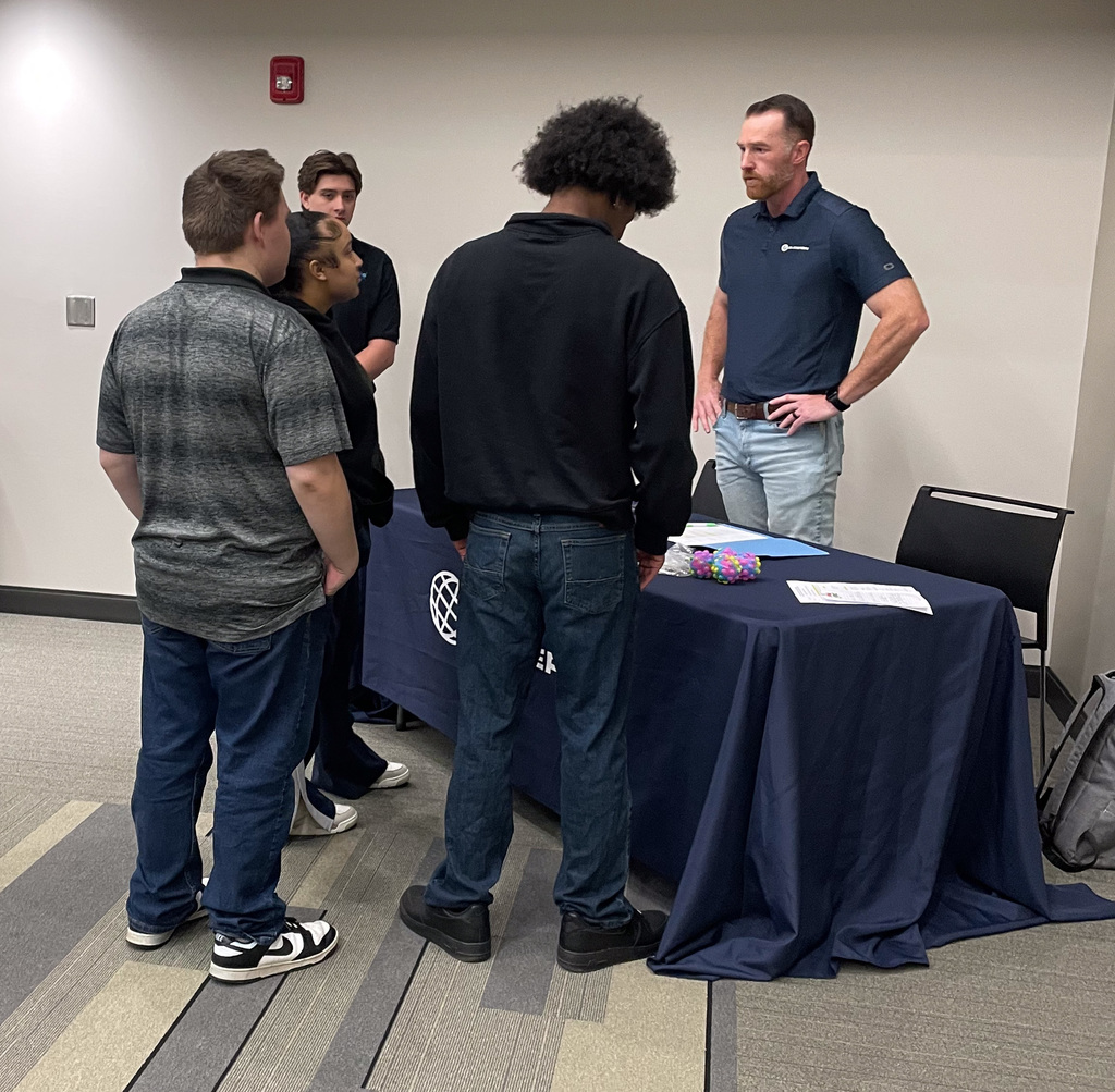 WOS students talking to a local manufacturing company representative
