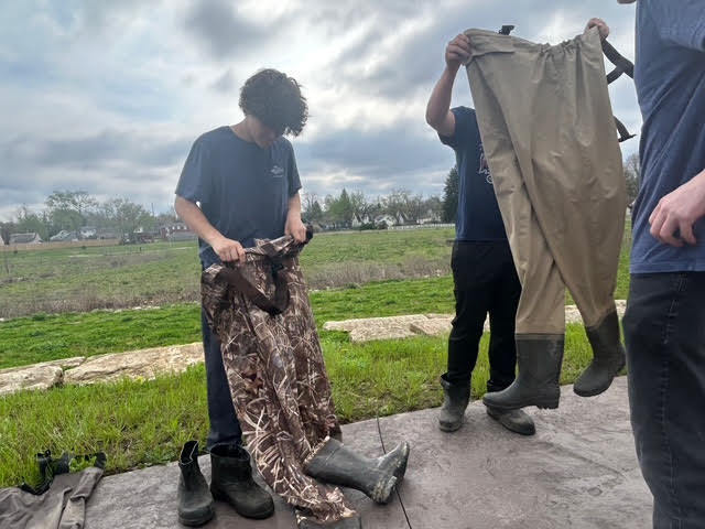 students putting on waders for the water