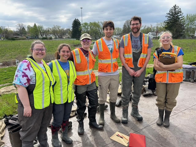 The Kent State Field Study group of scientists dressed for wading in the water with neon vests