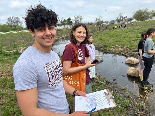 Student smiling with 8th grade science teacher mrs. frost