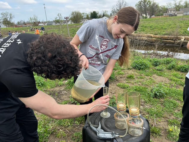 Two students measuring water samples