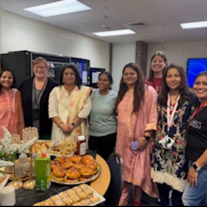 staff members sharing food for Eid celebration