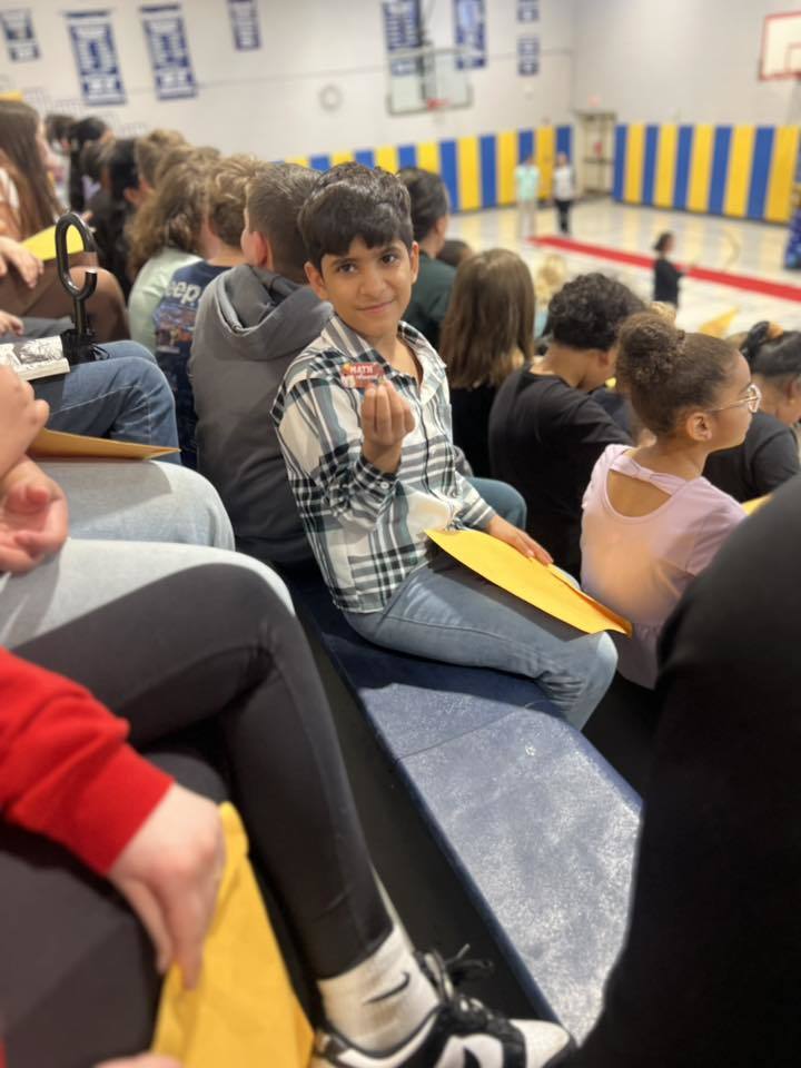 A student showing his award. 