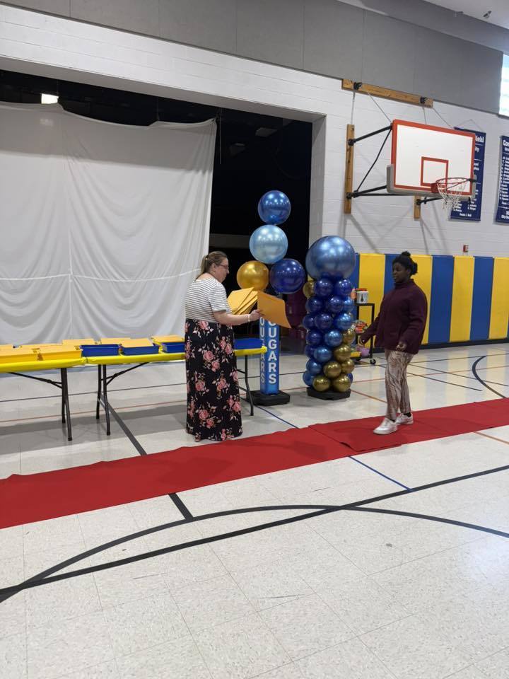 Students accepting their awards during the Awards assembly. 