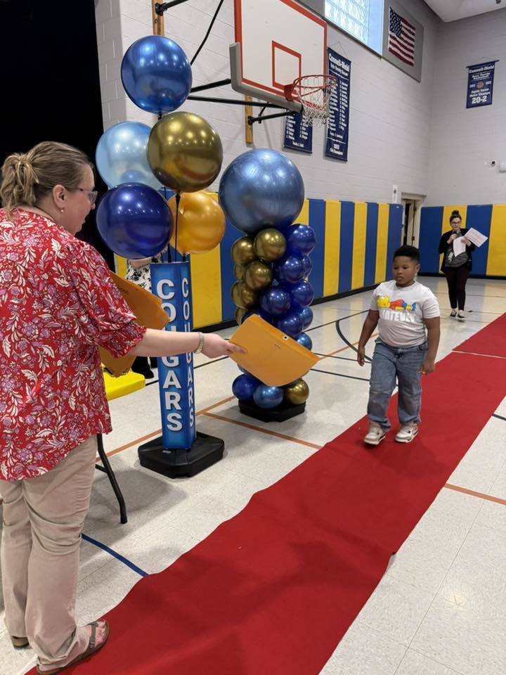 Students accepting their awards during the Awards assembly. 
