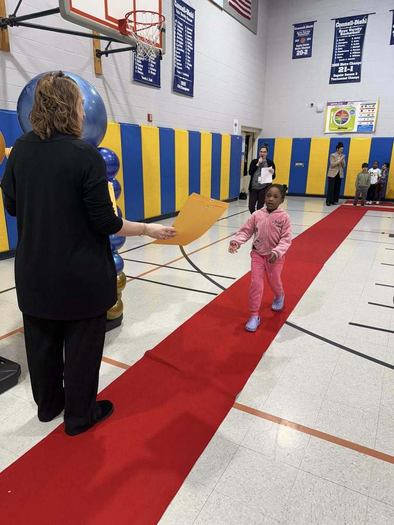 A student accepting their awards during the Awards assembly. 