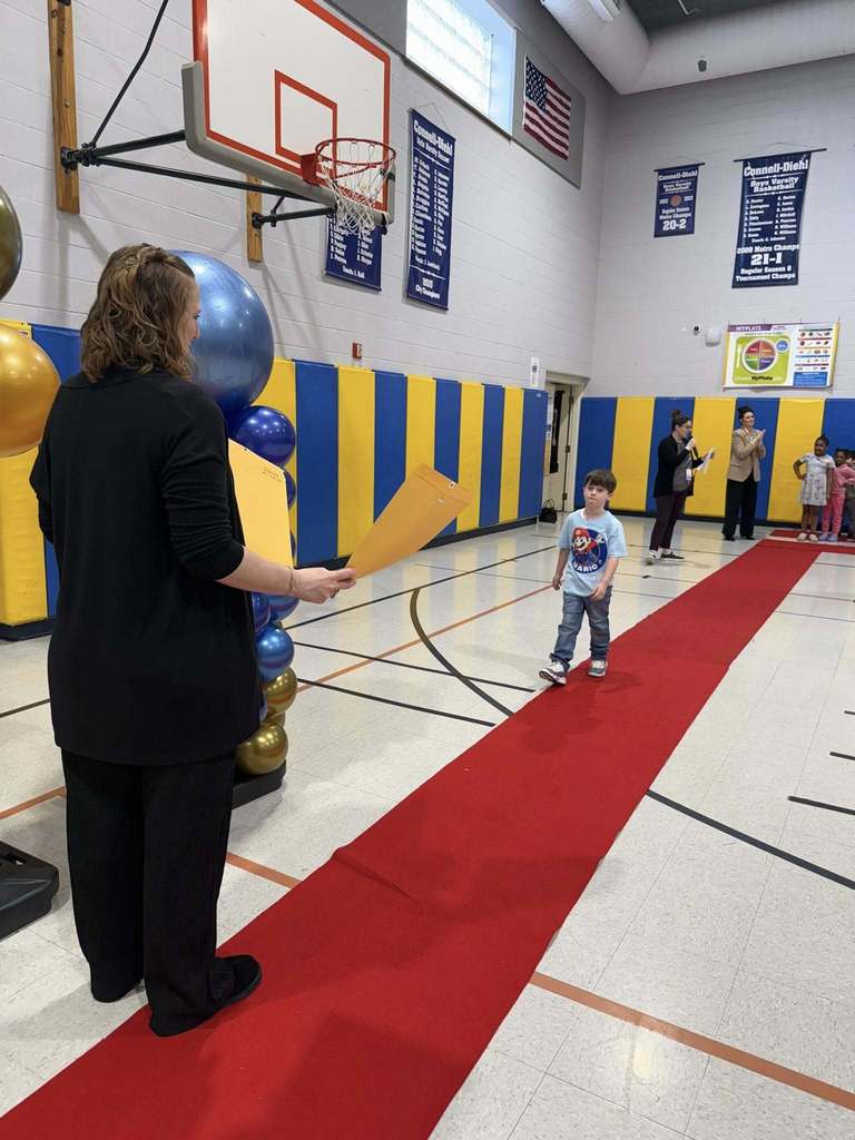 A student accepting their awards during the Awards assembly. 