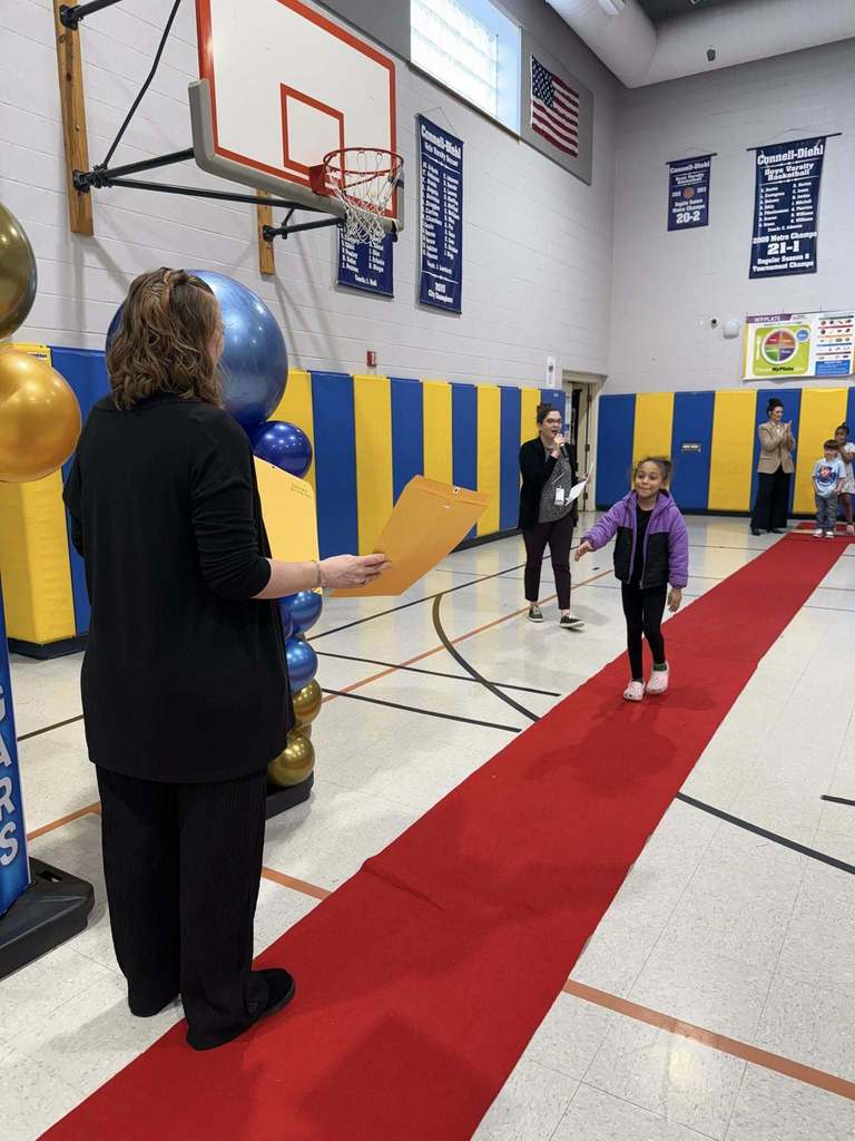 A student accepting their awards during the Awards assembly. 