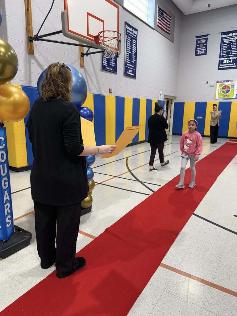 A student accepting their awards during the Awards assembly. 