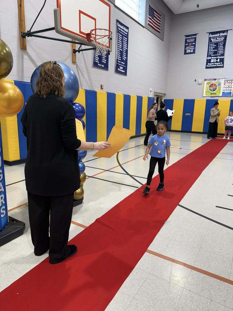 A student accepting their awards during the Awards assembly. 