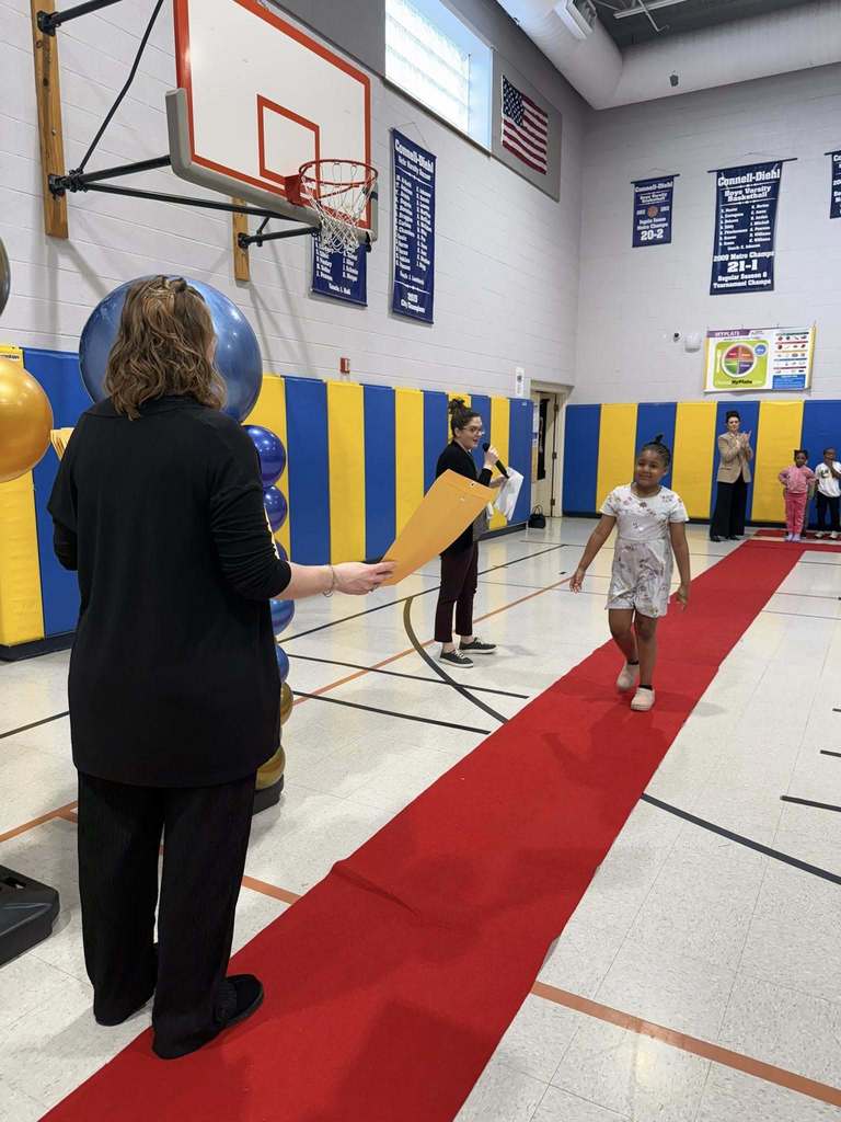 A student accepting their awards during the Awards assembly. 
