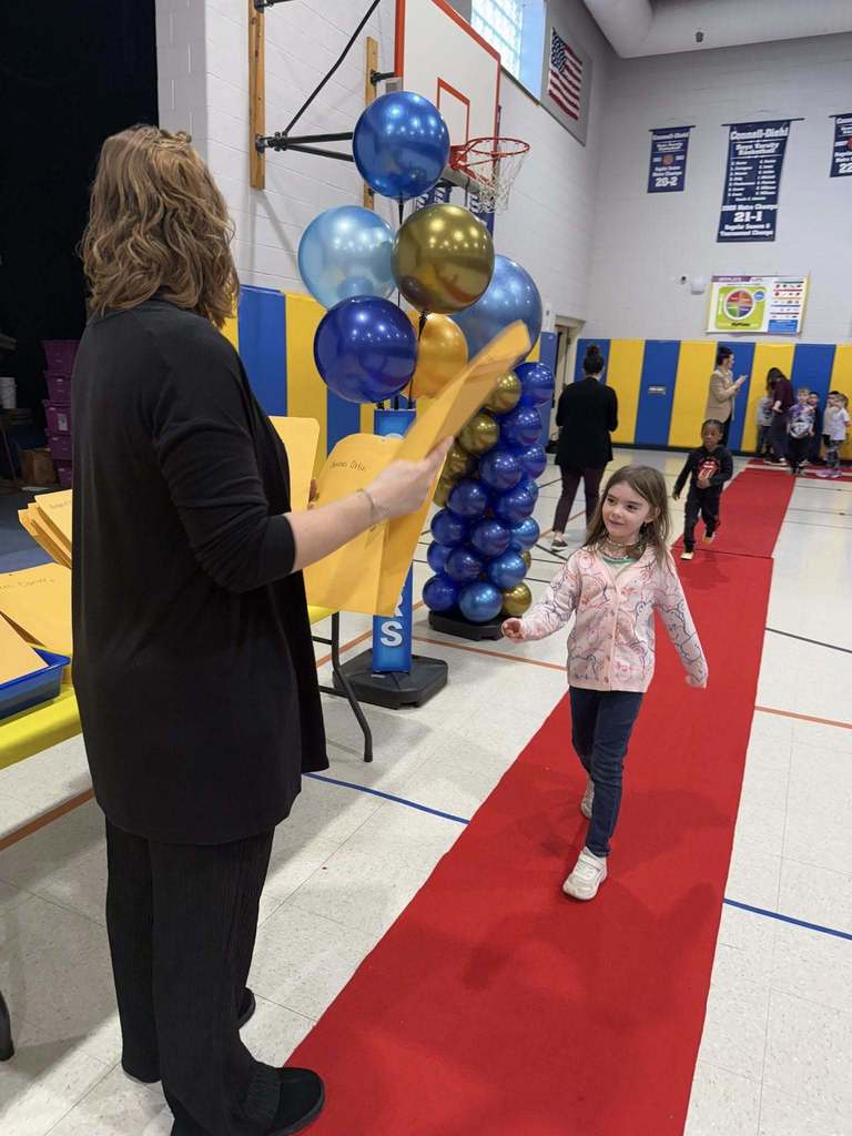 A student accepting their awards during the Awards assembly. 