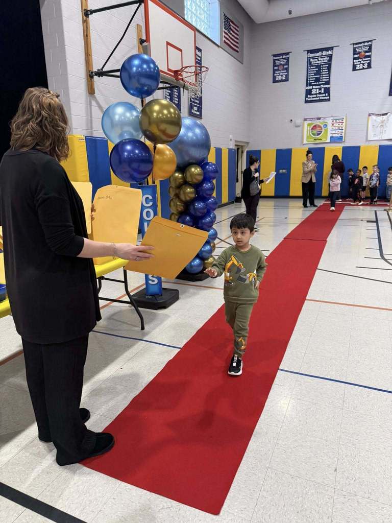 A student accepting their awards during the Awards assembly. 