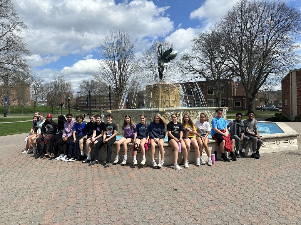 group of students sitting at a fountain at Elmira College