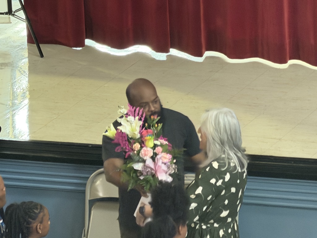 A man giving a women flowers. 