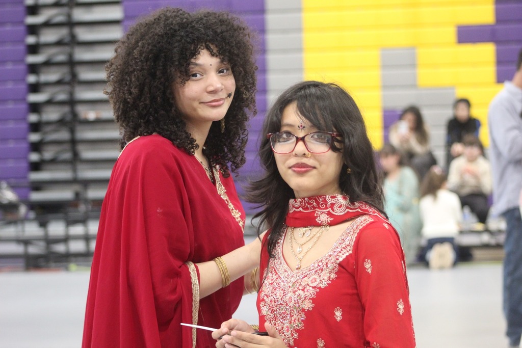 Two young women posing in cultural wear. 