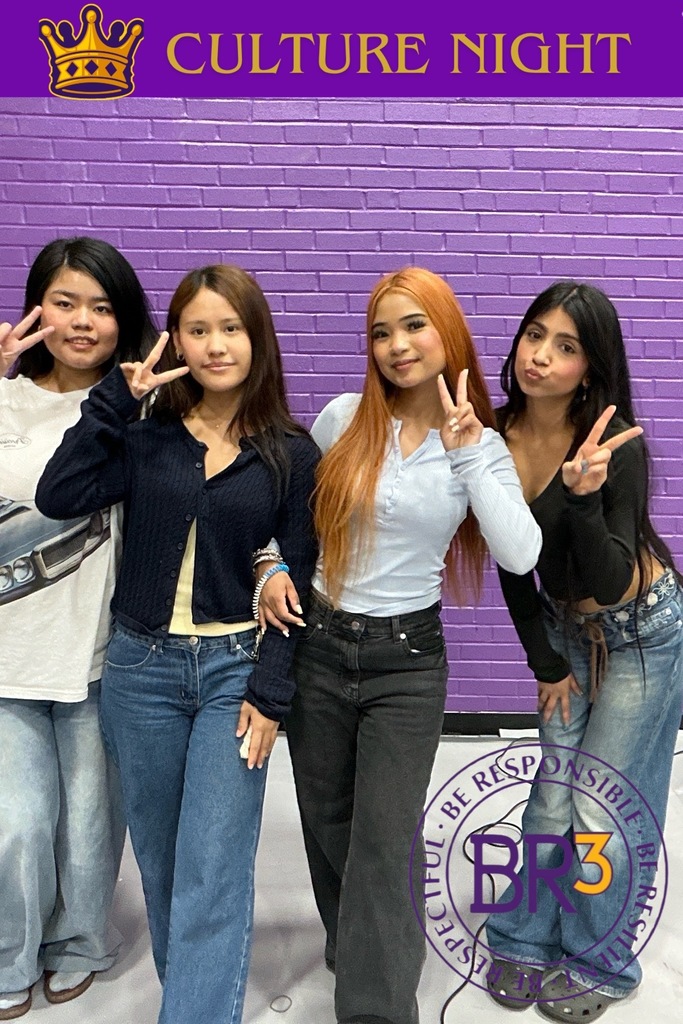 A group of girls holding peace signs up with a banner at the top of the photo that says "Culture Night".