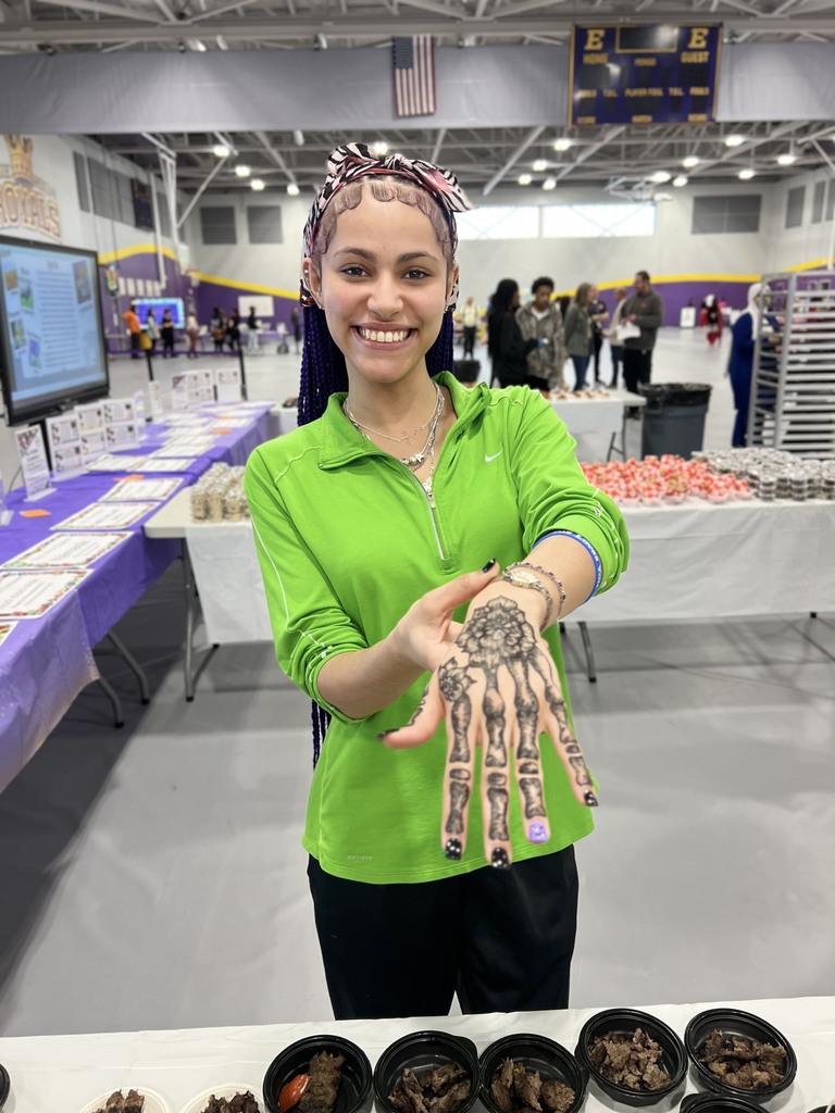 A student showing their henna on their hand. 