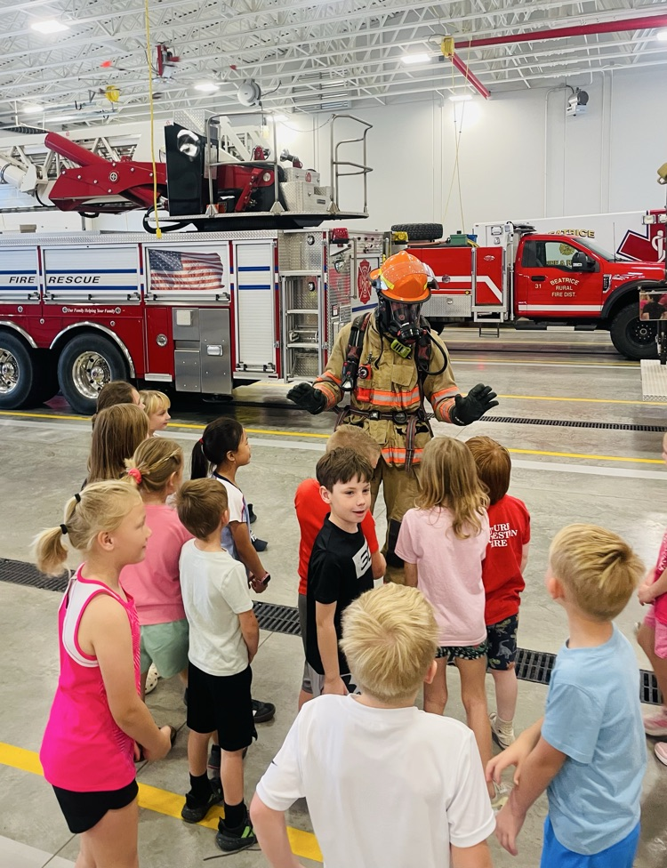 first graders touching fire gear 