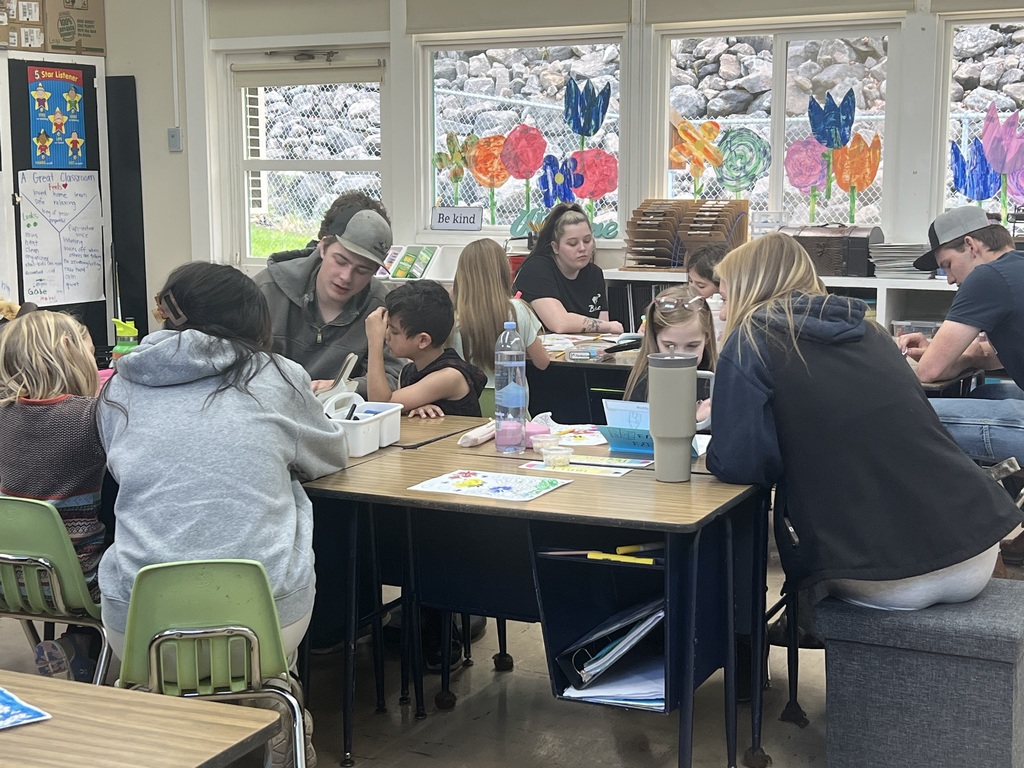 High school students helping 2nd grade students 