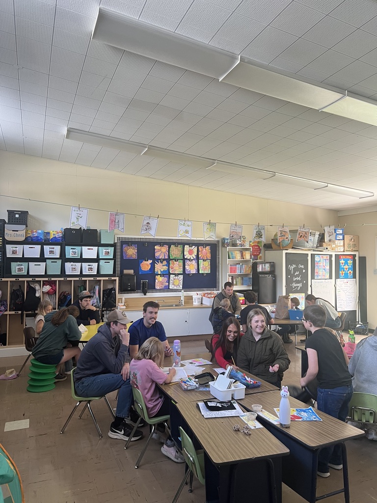 High school students helping 2nd grade students 