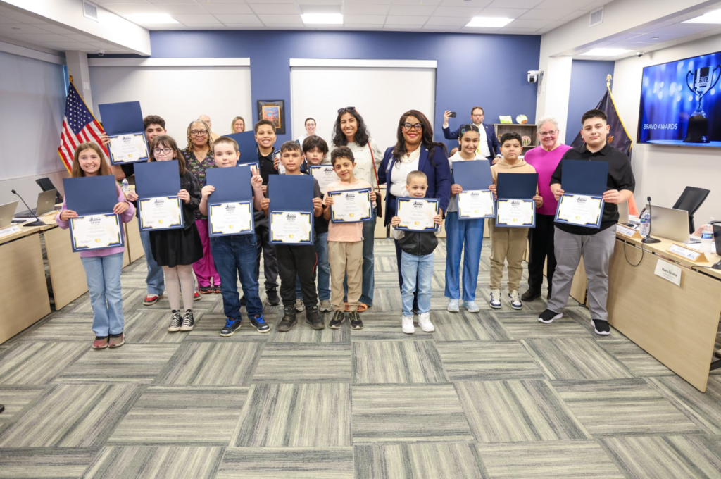 April's Bravo Award recipients standing with Dr. Gibbs and they are all holding their certificates. 