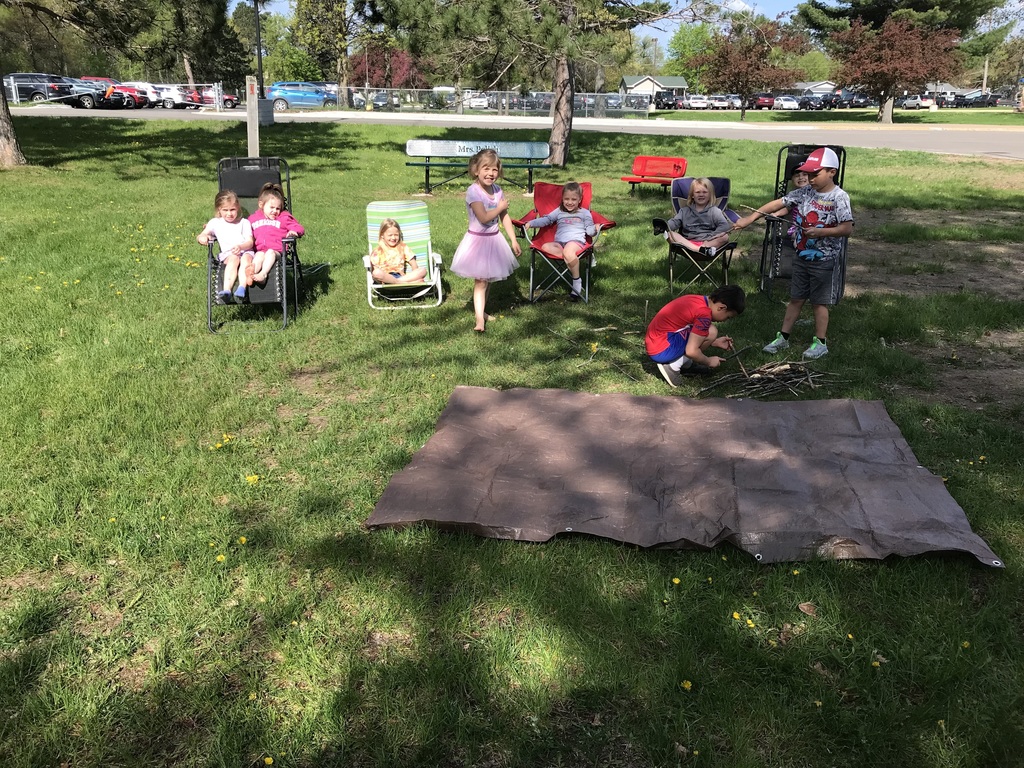 kids sitting in camo chairs