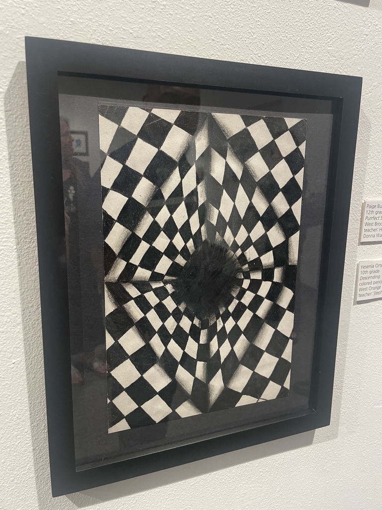 student drawing of a checkered black and white pattern descending into a hole