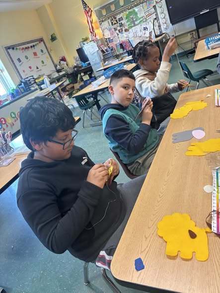 Students sewing to make animals. 
