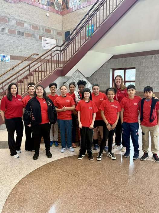 A group of students wearing matching red shirts. 