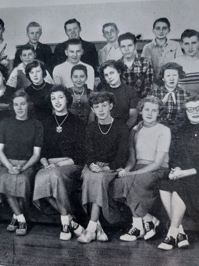 Old black and white photograph of the students from the Class of 1956 sitting and posing for picture.
