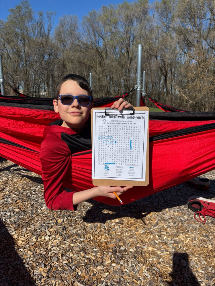 student in outdoor hammock