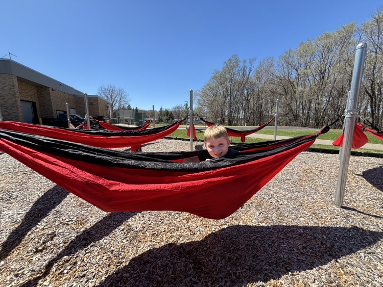 student in outdoor hammock