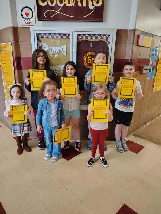 A group of students holding their "Cool Cougars" awards. 