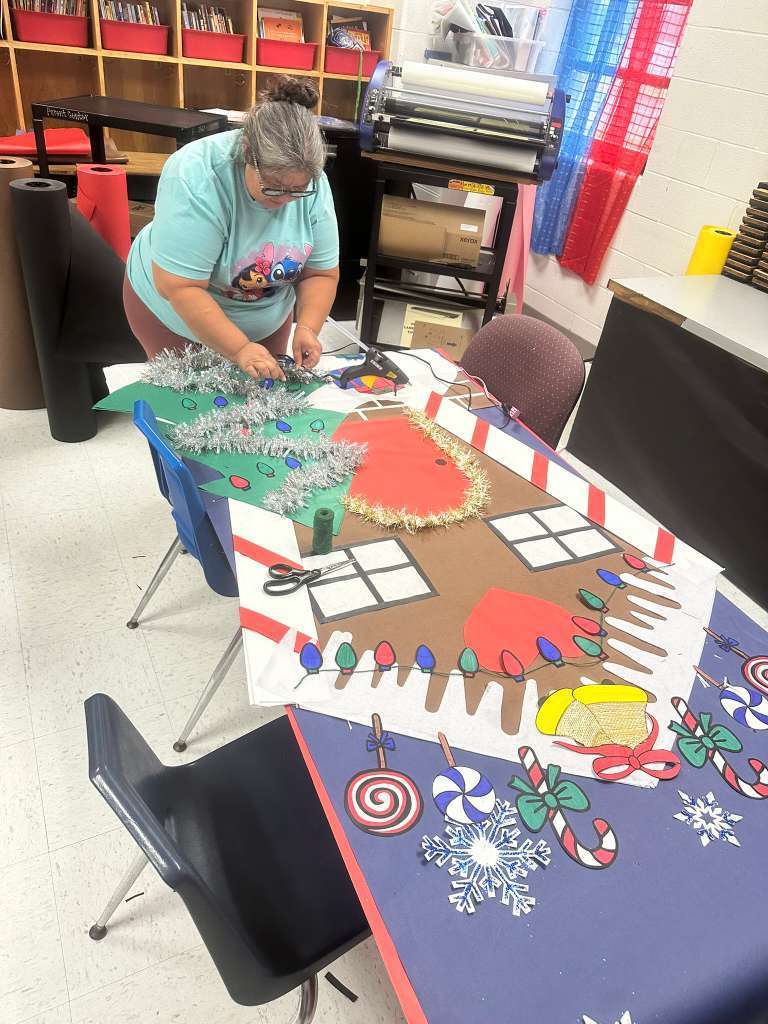 Woman with glasses making christmas tree decor