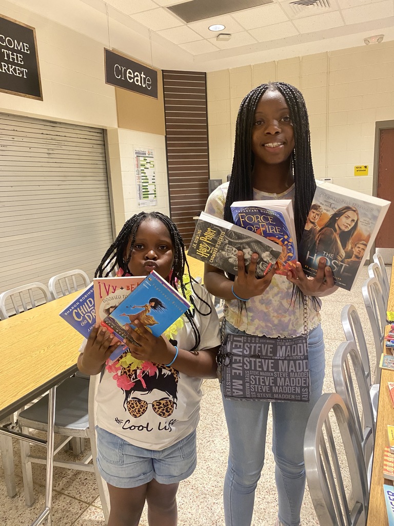 Two students hold the free books they took home