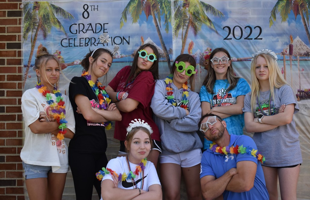 A group of TMS 8th graders are silly in the photo booth.