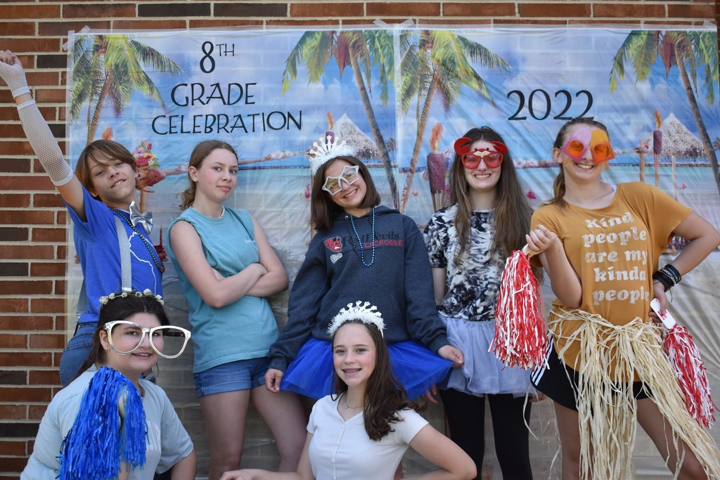 Students in their silly outfits pose in the photo booth.