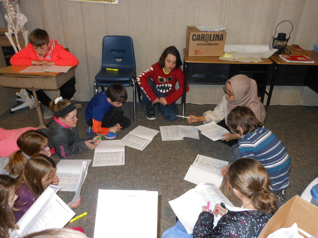 4th graders practice their own Reader's Theater scripts.